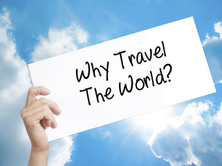  Why Travel The World? Sign on white paper. Man Hand Holding Paper with text. Isolated on sky background