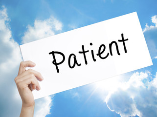 Patient Sign on white paper. Man Hand Holding Paper with text. Isolated on sky background