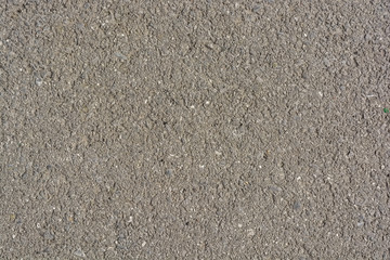 Abstract background of closeup dark uneven asphalt