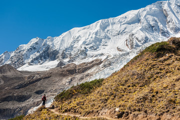 Fototapeta na wymiar Trekker in front of Manaslu glacier on Manaslu circuit trek in Nepal