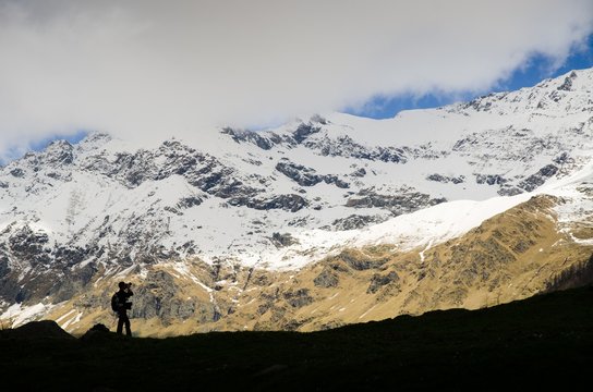 Photographer between the mountains (Val Soana, Gran Paradiso National Park, Italy)