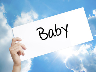 Baby Sign on white paper. Man Hand Holding Paper with text. Isolated on sky background