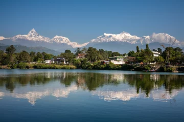 Foto op Plexiglas View at Annapurna mountain range and its reflection in Phewa lake in Pokhara, Nepal © Maygutyak
