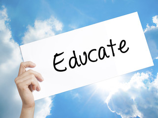 Educate Sign on white paper. Man Hand Holding Paper with text. Isolated on sky background
