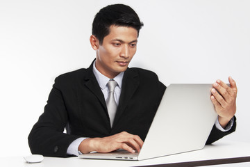 Businessman looking laptop for a business  market worldwide on white background.