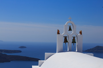 Santorini island in Greece - White church on blue background