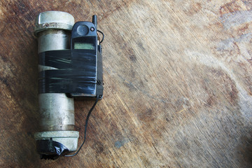 Steel pipe explosive (IED) is ignited by cell phone.For texture and background.