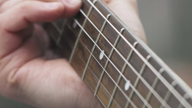 Playing electric guitar close-up fingers