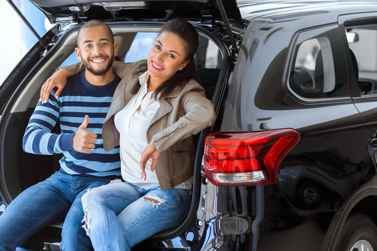 Loving Couple Buying A Car From A Car Dealer