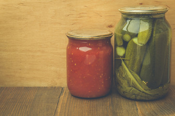 Tinned vegetables on a wooden background/In rural style. Tinned vegetables on a wooden surface