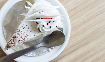 Closeup top view milk cake on wood table in coffee shop, selective focus