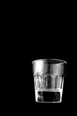 Empty shooter glass on black background, with copy space
