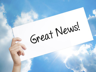Great News! Sign on white paper. Man Hand Holding Paper with text. Isolated on sky background