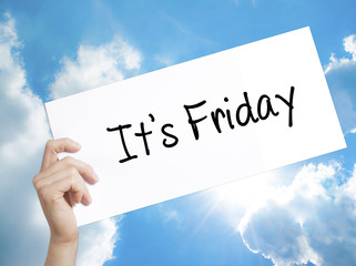 It's Friday Sign on white paper. Man Hand Holding Paper with text. Isolated on sky background