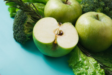 Flat lay of green vegetables on bright background
