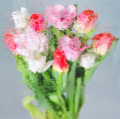 Background with flowers under glass with water drops on it