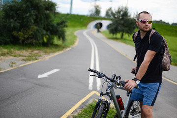 Fototapeta premium Portrait man cyclist riding in the park