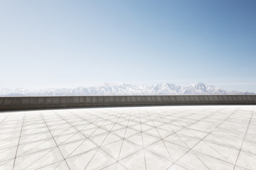 empty brick floor with white snow mountain