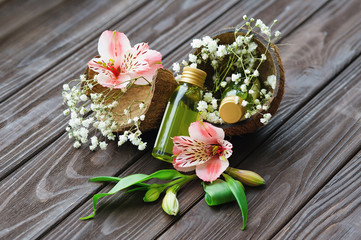 Obraz na płótnie Canvas Skin care products, flowers and coconut shell, organic cosmetics