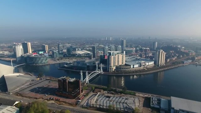 Panning aerial shot of Media City and Salford Quays in Manchester, UK.