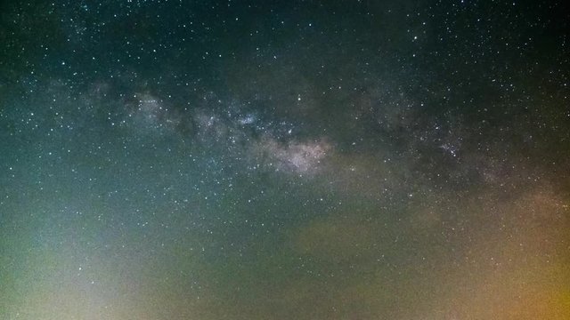 The video clip "time lapse of wide night sky landscape  with milky way galaxy going up and many shooting stars.