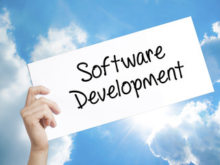 Software Development Sign on white paper. Man Hand Holding Paper with text. Isolated on sky background
