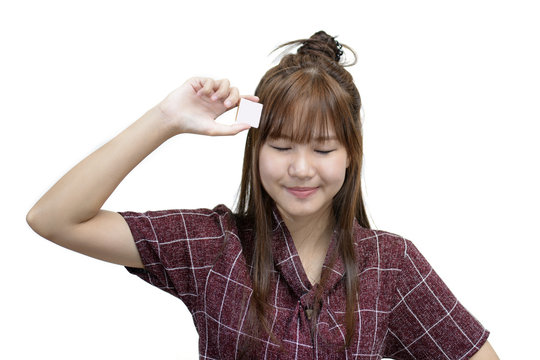 Asian woman close her eyes and thinking with smile over white background