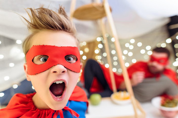 Close-up portrait of excited little boy in superhero costume looking at camera © LIGHTFIELD STUDIOS