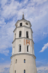 Fototapeta na wymiar Snow-white bell tower in Vilnius on the background of blue sky