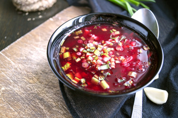 homemade rustic food. beetroot soup with green onions