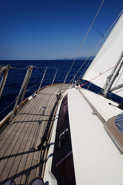Yacht sails on the blue sea