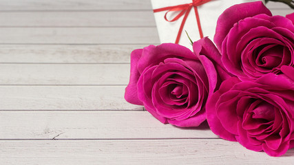 Romantic composition with rose flowers and gift St. Valentines Vedding Day background