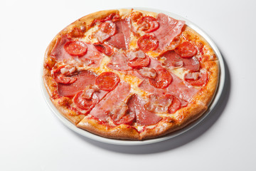 Italian delicious pizza with mushrooms and ham.