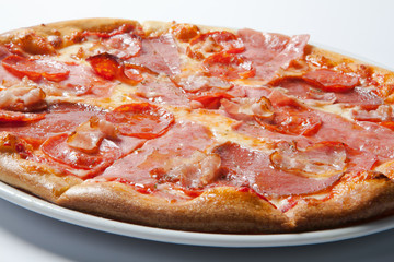 Italian delicious pizza with mushrooms and ham.