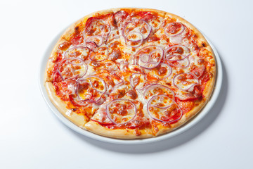 Pizza with onion, ham, cheese and tomato. White background
