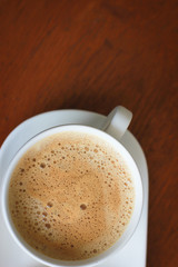 Coffee with white cup on wooden background