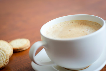 Coffee with white cup on wooden background