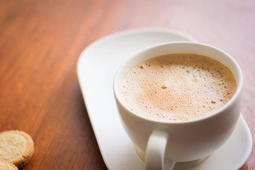 Coffee with white cup on wooden background