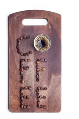 Word coffee made of beans over wooden background