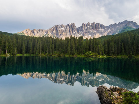 Italy, Veneto, Karersee lake and the Latemar mountain group at sunset