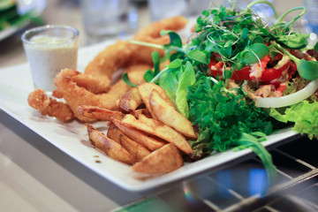 Fried fish, french fries and Vegetable salad.
