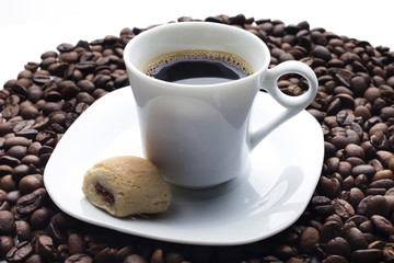 Cup and coffee over beans background