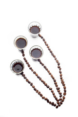 Abstract form made of coffee beans over white background