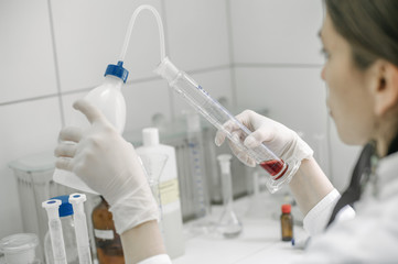 Female laboratory researcher performs tests