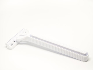 Closeup of white plastic shaver isolated on white background.