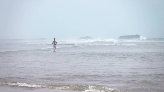 High quality video of jogging in the ocean waves in real 1080p slow motion 250fps