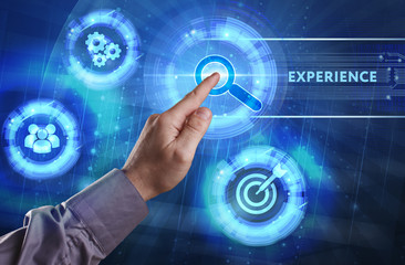 Fototapeta premium Business, Technology, Internet and network concept. Young businessman working on a virtual screen of the future and sees the inscription: Experience