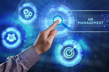 Business, Technology, Internet and network concept. Young businessman working on a virtual screen of the future and sees the inscription: HR management