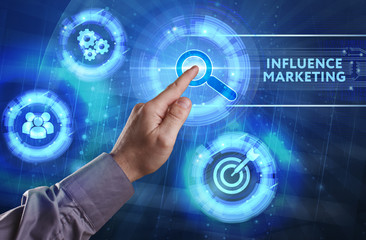 Business, Technology, Internet and network concept. Young businessman working on a virtual screen of the future and sees the inscription: Influence marketing