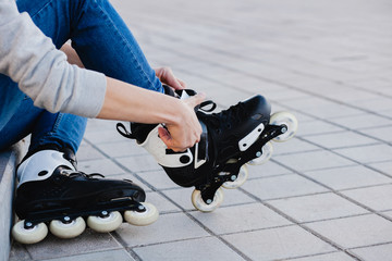 Plakat Closeup of man guy putting on roller skates outdoor.